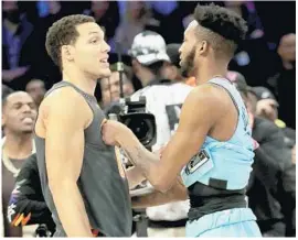  ?? JONATHAN DANIEL/TNS ?? Magic’s Aaron Gordon (left) and Heat’s Derrick Jones meet after theSlam Dunk Contest on Feb. 15.