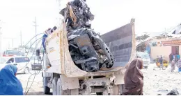  ??  ?? A truck carries wreckage of a car used in a car bomb in Mogadishu, Somalia.