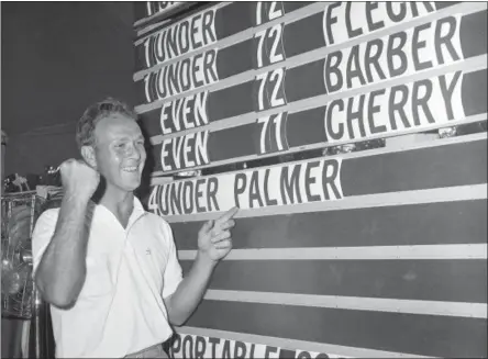  ?? FILE — THE ASSOCIATED PRESS ?? This file photo shows Arnold Palmer pointing to his name on the press tent scoreboard showing his four-under-par total, for 72 holes, during the National Open golf tournament at the Cherry Hills Country Club in Denver, Colo. Palmer, who made golf...