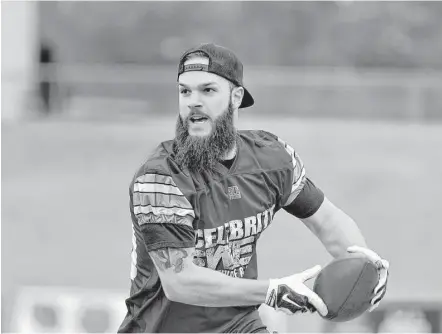  ?? Jerry Baker ?? Astros ace Dallas Keuchel, a Team Flutie captain, runs for yards after a catch in the first quarter of the Celebrity Flag Football Challenge on Saturday at Rhodes Stadium in Katy. Keuchel helped Flutie’s team hang on to beat the team led by Kirk Cousins.