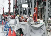  ?? KIMIMASA MAYAMA/AFP/ GETTY IMAGES ?? Staff build an ice wall at the tsunami-crippled Tokyo Electric Power Co.’s Fukushima Daiichi Nuclear Power Plant in 2014. The disaster triggered the start of Cameco’s difficulti­es.