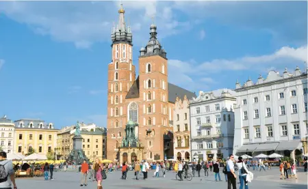  ?? CAMERON HEWITT ?? Krakow’s main square offers a vibrant slice of modern Polish life — and it’s just steps away from a cheap and cheerful milk-bar meal.