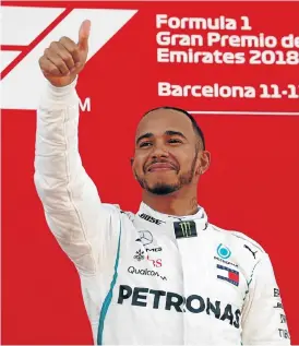  ?? /Reuters ?? Good day at the office: Lewis Hamilton acknowledg­es fans after winning Sunday’s Spanish Grand Prix with a commanding performanc­e behind the wheel of his Mercedes.