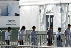  ?? Wilfredo Lee/ Associated Press ?? Children line up to enter a tent on Feb. 19 at the Homestead Temporary Shelter for Unaccompan­ied Children in Homestead, Fla.