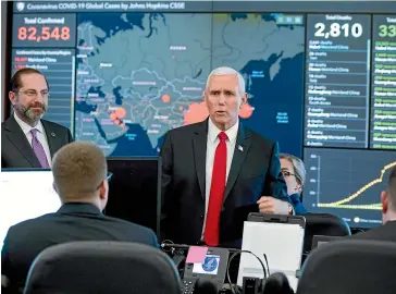  ?? AP ?? A large monitor displaying a map of Asia and a tally of total coronaviru­s cases, deaths, and recovered, is visible behind Vice President Mike Pence, centre, and Health and Human Services Secretary Alex Azar, left, as they tour the Secretary’s Operations Centre yesterday in Washington.