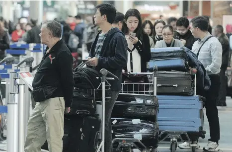  ?? NICK PROCAYLO ?? Staff at Vancouver Internatio­nal Airport were on hand on Tuesday to help explain the new rules on transporti­ng marijuana. The key message? If you’re travelling to the United States or any country internatio­nally, leave your cannabis at home. See full story on A9.