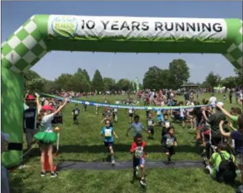  ??  ?? Hundreds of kids race towards a healthier lifestyle in Rose Tree Park Sunday as the Healthy Kids Running Series celebrated its 10th anniversar­y. Nearly 1,000 people attended the 10 Fest Celebratio­n, which also included moon bounces, face painting and food trucks.