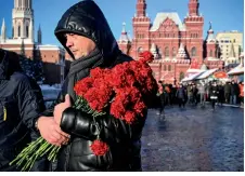  ?? ?? Russian communist supporters a end a flower-laying ceremony at the mausoleum of the founder of the Soviet state, Vladimir Lenin, to mark the 100th anniversar­y of his death, in Moscow.