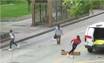  ?? U.S. DISTRICT COURT RECORDS ?? Federal prosecutor­s say this picture depicts Lamar Taylor (right) and Denzal Stewart (left) outside a CTA van that would soon be engulfed in flames.