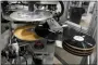  ?? MARK HUMPHREY - THE AP ?? Freshly pressed vinyl records are produced in a stamper at the United Record Pressing facility June 23, in Nashville, Tenn.