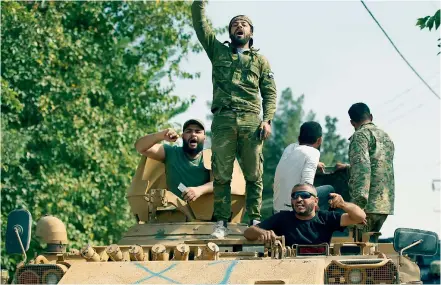  ?? AP ?? Turkish-backed Syrian opposition fighters chant slogans as they wait to cross the border into Syria, in Akcakale, Sanliurfa province, southeaste­rn Turkey, on Friday. —