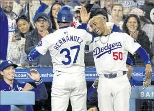  ?? Photograph­s by Gina Ferazzi Los Angeles Times ?? LEFT FIELDER Teoscar Hernández is greetd by Mookie Betts after his three-run home run in the sixth inning Monday. Hernández has four homers this season, tying Betts for the MLB lead.