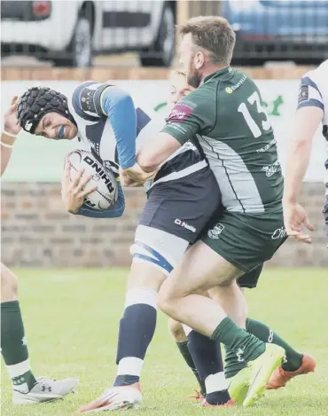  ??  ?? 0 Lee Armstrong, scorer of Hawick’s solitary try, holds on to Heriot’s flanker Jack Mclean.