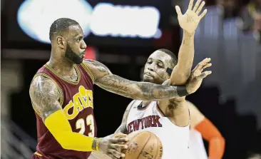  ?? — AP ?? Get out of the way: Cleveland Cavaliers’ LeBron James (left) tries to get past New York Knicks’ Lance Thomas in the NBA game in Cleveland on Thursday.