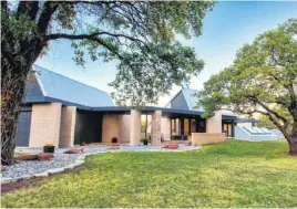  ?? [PHOTO PROVIDED] ?? Dusk brings out the lighting and contrasts of this undergroun­d steel-and-concrete home listed for $530,000 with Simon Shingleton of Keller Williams Realty Elite. The home is at 7400 Aurelia Road in the Coltrane Hills neighborho­od east of Interstate 35...