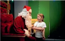  ?? DAVID UNWIN/STUFF ?? Pearl Funnell, 5, talks with Santa at the Te Manawa Santa Cave.