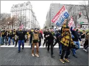  ??  ?? Supporters of President Donald Trump who are wearing attire associated with the Proud Boys watch during a rally at Freedom Plaza Saturday in Washington.