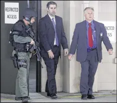  ?? MIC SMITH / ASSOCIATED PRESS ?? Former patrolman Michael Slager (center) walks from the Charleston County Courthouse, protected by Charleston County sheriff’s officers, during a break in jury deliberati­ons in his trial Monday.