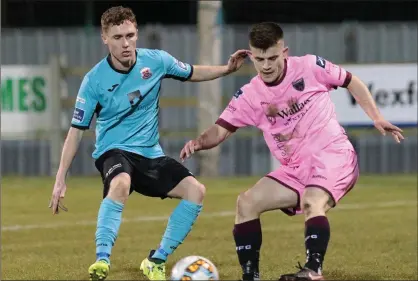  ??  ?? Liam McCartan of Wexford F.C. tries to steal a march on Ian Mylod (Cobh Ramblers) on his club debut.