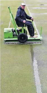  ?? PHOTO: PETER MCINTOSH ?? Squelch . . . Colin Wheeler rolls the No 2 green after overnight rain before the North East Valley 10,000 Bowls started yesterday.