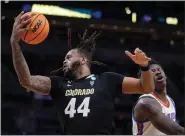  ?? MICHAEL CONROY — THE ASSOCIATED PRESS ?? Colorado center Eddie Lampkin Jr. catches a pass in front of Florida forward Tyrese Samuel on Friday in Indianapol­is.