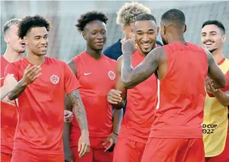  ?? — AFP ?? Canada’s players interact as they take part in a training session at the Umm Salal SC in Doha.