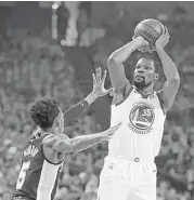  ?? Ben Margot / Associated Press ?? The Warriors’ Kevin Durant, right, hurt the Spurs with 24 points, eight rebounds and seven assists.