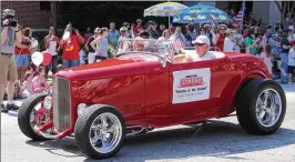  ?? COURTESY THE EARL AND RACHEL SMITH STRAND THEATRE ?? Earl and Rachel Smith drove a red hot rod in the Marietta July 4 parade in 2007 to promote saving the Strand Theatre. The couple played a key role in saving the downtown art deco landmark, now the Earl and Rachel Smith Strand Theatre.