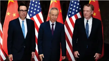  ?? AP PHOTO BY NG HAN GUAN ?? Chinese Vice Premier Liu He, center, poses with U.S. Trade Representa­tive Robert Lighthizer, right, and Treasury Secretary Steven Mnuchin, for photos before holding talks at the Xijiao Conference Center in Shanghai Wednesday.