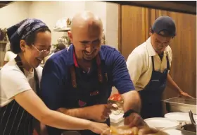  ?? Supplied ?? Indonesian chef Michelle Santoso, left, and Palestinia­n chef Murad Halayqa prepare a family-style Palestinia­n dinner in
Jakarta on
Jan. 28, 2024.