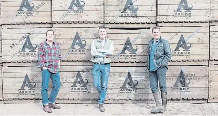  ??  ?? From top: Caroline Bruce-jarron with a bottle of Ogilvy vodka made from Maris Piper potatoes and Graeme Jarron holding some young plants; brothers Iain, John and David Stirling at the Arbikie Distillery; a bottle of chilliflav­oured vodka from Arbikie.