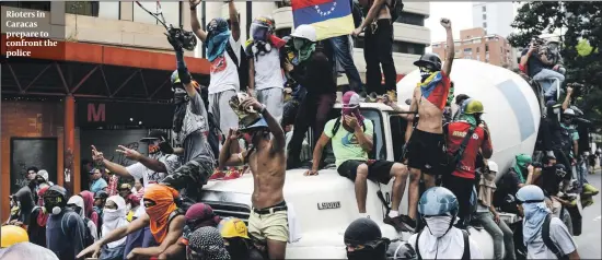  ?? PHOTOS: GETTY IMAGES ?? Rioters in Caracas prepare to confront the police
