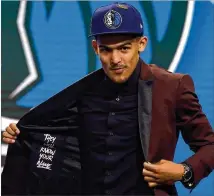  ?? MIKE STOBE/GETTY IMAGES ?? Former University of Oklahoma point guard Trae Young reacts after being drafted fifth overall by the Mavericks in June. He waspromptl­y traded to the rebuilding Hawks.