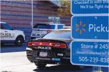  ?? LIAM DEBONIS/JOURNAL ?? Police respond to a shooting in the employee break room of the Walmart Neighborho­od Market on Friday afternoon in Northeast Albuquerqu­e.