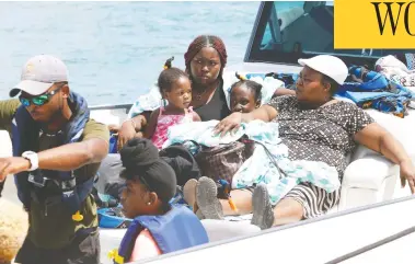  ?? JOSE JIMENEZ / GETTY IMAGES ?? Private boats help evacuate families Friday at the Marsh Harbor Port in Hurricane Dorian devastated Grand Abaco
Island in the Bahamas. The storm is making its way north and is expected to hit Atlantic Canada this weekend.