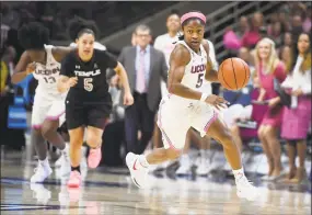  ?? Jessica Hill / Associated Press ?? UConn’s Crystal Dangerfiel­d takes off after intercepti­ng a pass for a steal during the first half against Temple on Saturday.