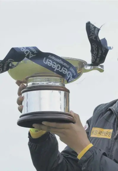  ??  ?? 0 Mi Hyang Lee is delighted after receiving the Ladies Scottish Open trophy. She endured a difficult