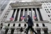  ?? RICHARD DREW — THE ASSOCIATED PRESS FILE ?? People walk by the New York Stock Exchange. U.S. stocks climbed Wednesday, driven by gains for big technology companies and Amazon.