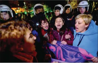  ?? — AFP photo ?? Turkish riot police surround women as they protest on the Internatio­nal Day for the Eliminatio­n of Violence Against Women, in Istanbul.