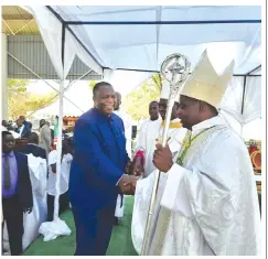  ?? ?? Acting President Dr Constantin­o Chiwenga shares a lighter moment with the clergy as he congratula­tes Bishop Eusebius Nyathi following his ordination in Gokwe yesterday