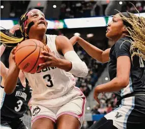  ?? Jessica Hill / Associated Press ?? UConn’s Aaliyah Edwards is guarded by Villanova’s Christina Dalce in the first half Sunday in Hartford.