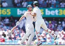  ?? AP ?? Australia’s Mitchell Marsh (right) celebrates with his brother, Shaun Marsh, after reaching that his century.