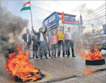  ?? PTI ?? Members of the Jammu high court bar associatio­n burn tyres during a bandh in the Kathua district on Wednesday.