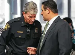  ?? Staff file photo ?? Police Chief William Mcmanus listens to then-deputy City Manager Erik Walsh in 2018. A town hall session on the police will be held Thursday.