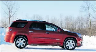  ?? PHOTOS: KEVIN MIO, THE GAZETTE ?? The 2013 GMC Acadia Denali can carry four-foot wide sheets of plywood. Its unique front fascia differenti­ates it from the rest of the Acadia lineup, and its interior is spacious. The steering wheel, however, could be a bit beefier.