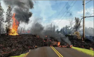  ?? U.S. GEOLOGICAL SURVEY ?? Lava from a fissure slowly advances to the northeast on Hookapu Street near Pahoa, Hawaii, on Saturday after Thursday’s eruption of Hawaii’s Kilauea volcano. The governor of Hawaii has declared a local state of emergency near the mountain.