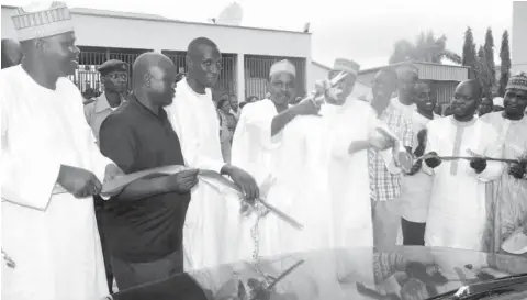  ??  ?? Chief Executive Officer/ Editor- in- Chief, Media Trust Ltd, Mannir Dan Ali, cuts the tape to flag-off the interstate distributi­on scheme at the company’s headquarte­rs in Abuja yesterday Newspapers’ Abdul Musa