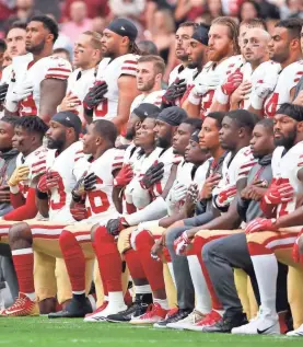  ?? MICHAEL CHOW/USA TODAY NETWORK ?? San Francisco 49ers players take a knee during the national anthem Oct. 1, 2017, before facing the Arizona Cardinals.