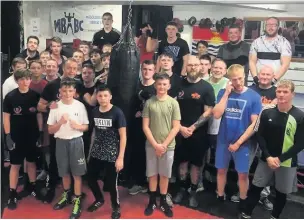  ??  ?? Members of Macclesfie­ld Boys Boxing Club with the punchbag