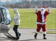  ??  ?? Santa Claus arrives via helicopter on Saturday, Dec. 9, at West Chester’s American Helicopter Museum and Education Center.